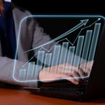 Entrepreneur analyzes economic and financial growth. Investment chart and economic trends.