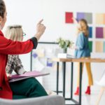 magazine editor pointing at color palette in modern office