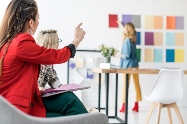 magazine editor pointing at color palette in modern office