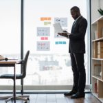 Manager planning strategy using laptop and graphic materials