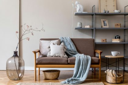 Modern interior design of living room with brown wooden sofa.